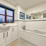 Modern bathroom with bathtub and sink.