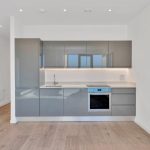 Modern grey kitchen with integrated appliances.