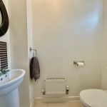 Modern bathroom with sink and toilet.