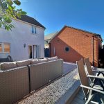 Modern patio with outdoor seating and decking area.