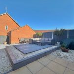 Modern garden with patio furniture and gravel landscaping.