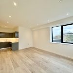 Modern open-plan kitchen and living area with window.