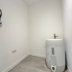 Storage room with boiler and electrical panel.