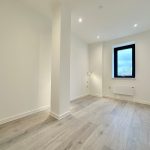Empty room with wooden floor and window.