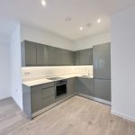 Modern grey kitchen with sleek cabinets.