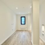 Empty modern room with wooden flooring