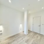 Modern minimalist room with wooden flooring.