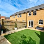 Modern house with fenced garden and patio