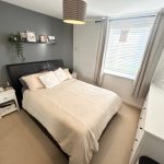 Modern bedroom with grey wall and white decor