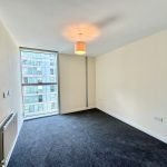 Empty modern room with grey carpet and window.
