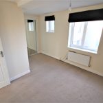 Empty room with beige walls and carpet