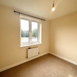 Empty room with beige walls and carpet