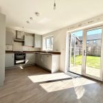 Modern kitchen with garden view and natural light.
