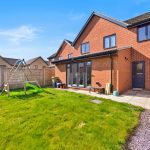 Red brick house with garden and playset