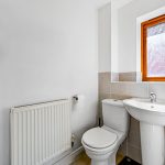 Small bathroom with toilet and sink.