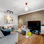 Modern living room with toys and playpen