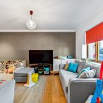 Modern living room with grey sofas and toys.