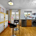 Modern kitchen with appliances and wooden cabinets.