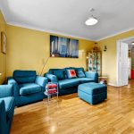 Bright living room with blue sofa and armchairs.