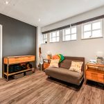 Cosy living room with sofa, wooden flooring, modern decor.