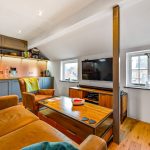 Cosy living room with sofa and TV