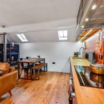 Modern open-plan kitchen and dining area with skylights.