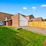 Modern brick house with driveway and garden