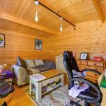 Cosy wooden home office with desk and chairs.