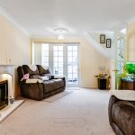 Cosy living room with fireplace and large windows