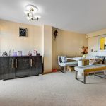 Modern living room with table and sideboard decor.