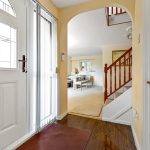 Bright home entrance with stairs and lounge view.