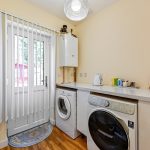 Utility room with washer, dryer, and outdoor view.