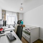 Modern home office with desk and single bed