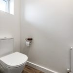 Minimalist bathroom with toilet and radiator