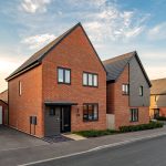 Modern brick houses on a residential street.
