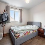Cosy bedroom with bed and window view.