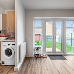 Laundry area with doors leading to garden.