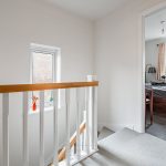 Home landing with stairs leading to bedroom view.
