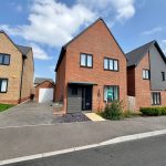 Modern brick house with driveway and garage.
