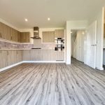 Modern kitchen with wooden cabinets and flooring