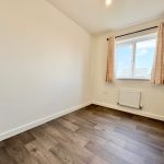 Empty room with wooden floor and window.