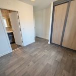 Empty room with wooden floor and sliding wardrobe door.