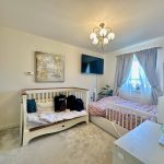 Cosy bedroom with cot and double bed.