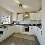Modern kitchen with white cabinets and appliances