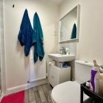 Small bathroom with towels, sink, and toilet.
