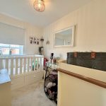 Cosy baby nursery with crib and wall decor.