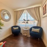 Cosy corner with chairs and decorative accents.