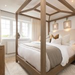 Elegant bedroom with canopy bed and wooden furniture.