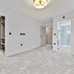Modern bedroom with en-suite shower and walk-in wardrobe.