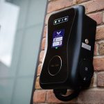 Electric vehicle charging station on brick wall